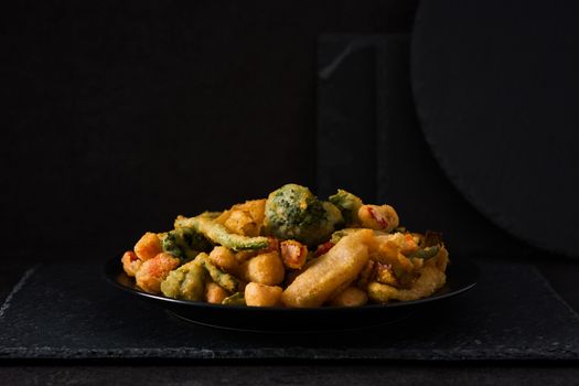 Japanese vegetable tempura on black background