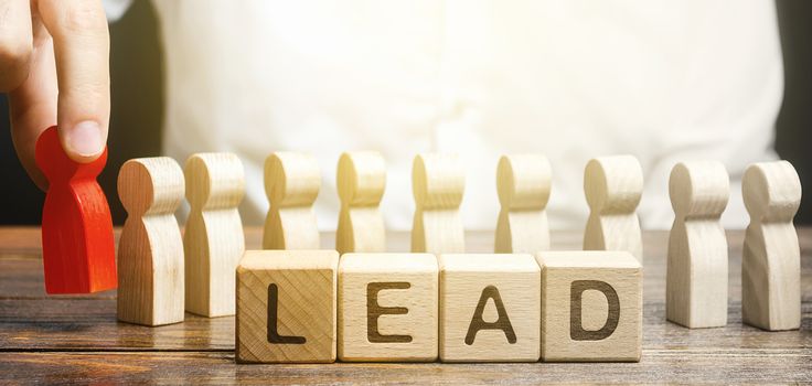 Man puts a leader at head of line of people. Project leadership. Appointment to a responsible post, strategic management planning. Distribution business optimization. Career promotion to leading post.