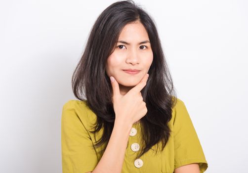 Portrait Asian beautiful young woman standing, She thinking or dreaming and looking to camera, shoot photo in studio on white background, There was copy space on the left hand side