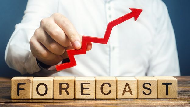 Man holds red arrow up over word Forecast. Budget surplus, optimistic price quotes, rise of company value. Prediction further development of situation. High demand, profitability, economic prosperity