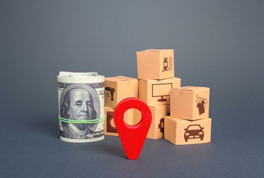 Cardboard boxes near money bundle and a red pointer. Delivery goods under closed borders, quarantine restrictions, import export. Critical transportation infrastructure. Distribution, freight shipment