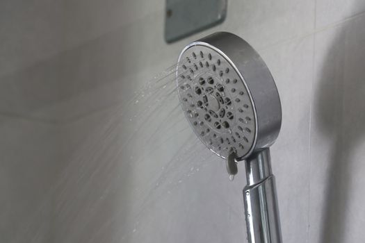 Water that flows out of the shower gently. Water flows out of the shower.
