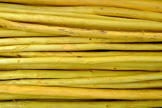 Close up Pile of Yellow Wood Sticks.