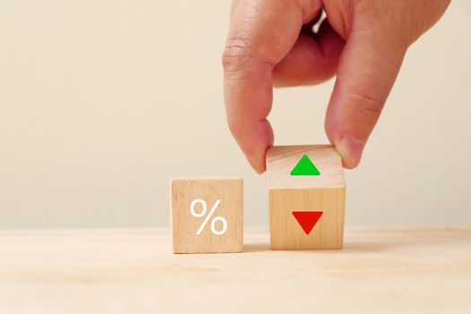 Percent sign on the wooden cube with arrow pointing up and down.