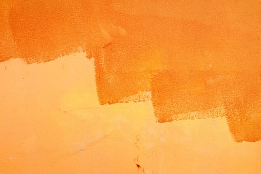 Unfinished Orange Paint on Concrete Wall Background.