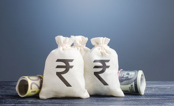 Indian rupee money bags. Capital investment, savings. Economics, lending business. Banking service, monetary policy. Profit income, dividends. Crowdfunding startups investing. Reserve currency.
