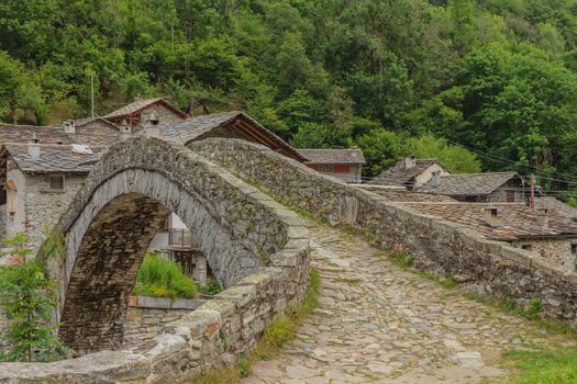 a romanesque bridge made of donkey back of  of the 17th century, at the entrance to the village of Fondo ,in Piedmont,Italy