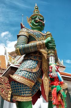 Siamese Giant Statue Standing in front of Thai Temple.