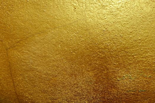 Dark Golden Paint on Stone Background.