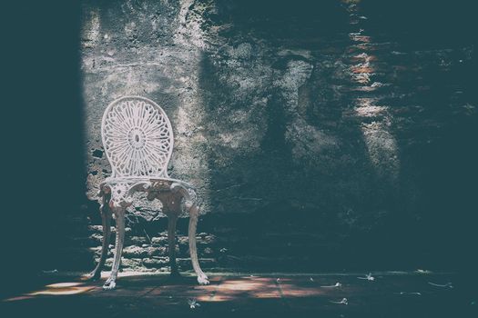 White Chair with Old Brick Wall Background in Vintage Style.