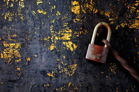 Old Lock Hanging on Old Peeling Wooden Door Background.