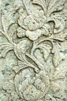 Vintage Thai Sculpture on Stone Wall.