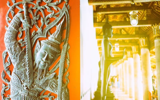 Ancient Vintage Thai Sculpture on Red Door at The Public Hallway of Wat Benchamabophit Temple.