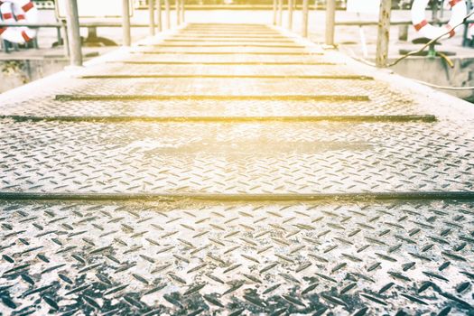 Diamond Plate Pathway to Pier Background with Light Leak.