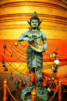 Ancient Thai angel statue on temple of the Golden Mount at Wat Saket temple Bangkok. It's famous Landmark of Thailand. (Translation Text is "Be healthy".)