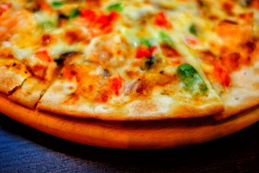 Close-up Pizza on Wooden Plate. (Selective Focus)