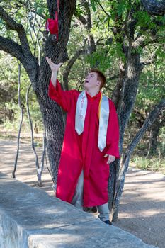 Handsome, red- headed young man posing for his High School graduation photos. Very attractive and athletic looking young boy.