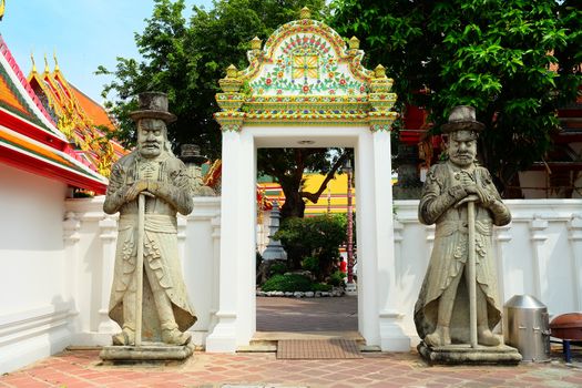 Ancient Guardian Giants in Front of Wat Pho Temple Entrance, Bangkok Thailand.