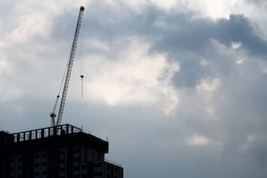 Silhouette of Under Construction Building in Cloudy Day with Space for Text.