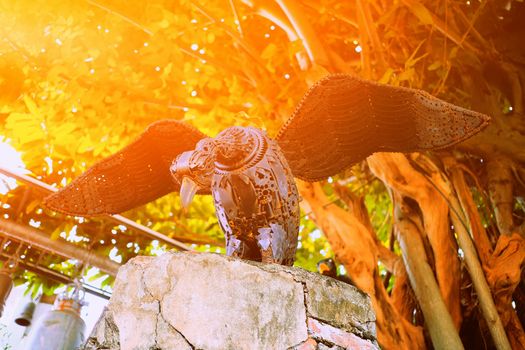 Old Metal Vulture Statue in Park with Light leak.