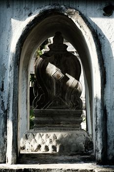 Sunlight Beam Shining on Ancient Heart-Shaped Stone Boundary Marker of Church in Thai Temple.