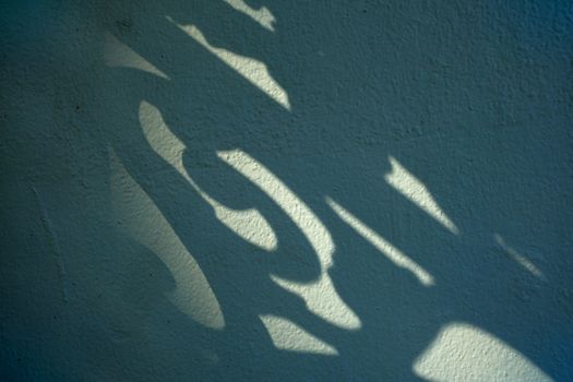 Shadow of Fence on Concrete Wall Background.