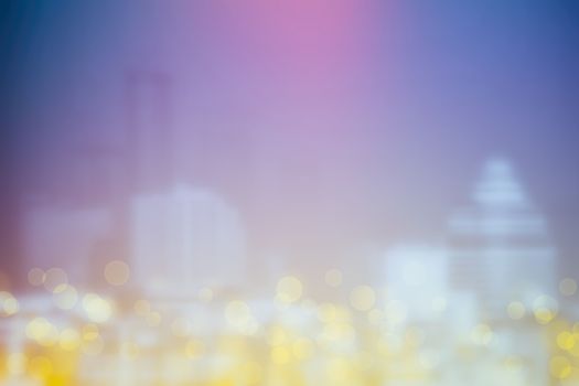 Abstract Yellow Bokeh with Blurred Cityscape Background.