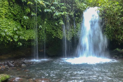 The Stream of Yeh Ho Waterfall, is located in the lush rice field-laden Penebel village in Tabanan near to Jatiluwih rice terrace in Bali, Indonesia. Beautiful waterfall in deep tropical jungle.