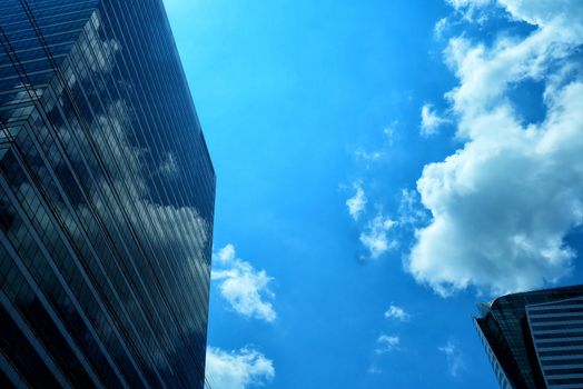 Modern Building with Clouds and Blue Sky Background.