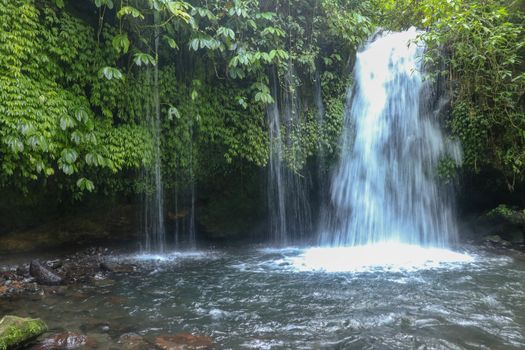 The Stream of Yeh Ho Waterfall, is located in the lush rice field-laden Penebel village in Tabanan near to Jatiluwih rice terrace in Bali, Indonesia. Beautiful waterfall in deep tropical jungle.