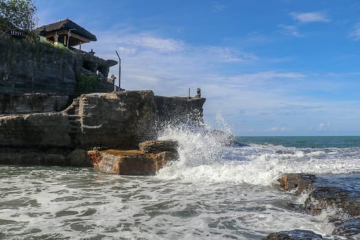 Beautiful Tanah Lot Temple in Bali Indonesia epic scene - nature and architecture background. Pilgrimage Temple of Pura Tanah Lot is perched dramatically on a large coastal rock.