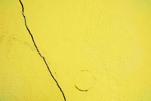 Broken Yellow Painted Concrete Wall.