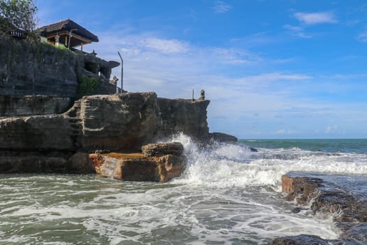 Beautiful Tanah Lot Temple in Bali Indonesia epic scene - nature and architecture background. Pilgrimage Temple of Pura Tanah Lot is perched dramatically on a large coastal rock.