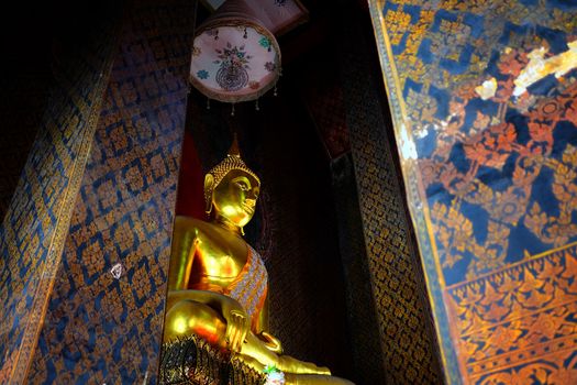 Ancient Golden Buddha image in main hall at Wat Intharam Temple Bangkok Thailand.