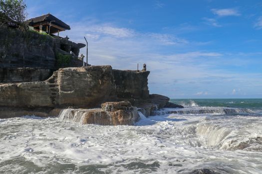 Beautiful Tanah Lot Temple in Bali Indonesia epic scene - nature and architecture background. Pilgrimage Temple of Pura Tanah Lot is perched dramatically on a large coastal rock.