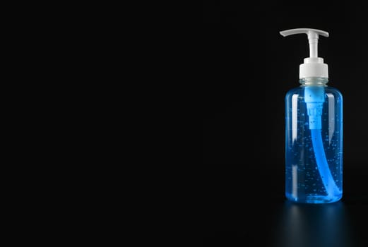Blue alcohol gel isolated on black background with copy space. Hand sanitizer gel for clean. Hand sanitizer in pump head bottle. 
