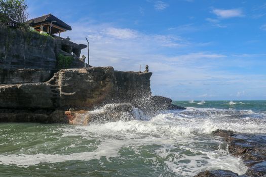 Beautiful Tanah Lot Temple in Bali Indonesia epic scene - nature and architecture background. Pilgrimage Temple of Pura Tanah Lot is perched dramatically on a large coastal rock.
