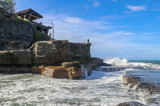 Beautiful Tanah Lot Temple in Bali Indonesia epic scene - nature and architecture background. Pilgrimage Temple of Pura Tanah Lot is perched dramatically on a large coastal rock.