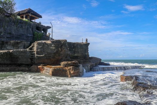 Beautiful Tanah Lot Temple in Bali Indonesia epic scene - nature and architecture background. Pilgrimage Temple of Pura Tanah Lot is perched dramatically on a large coastal rock.