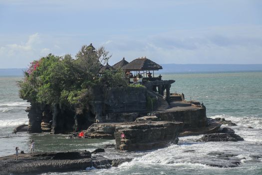 Beautiful Tanah Lot Temple in Bali Indonesia epic scene - nature and architecture background. Pilgrimage Temple of Pura Tanah Lot is perched dramatically on a large coastal rock.