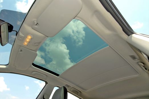 the inside of the car with a semi-open sunroof
