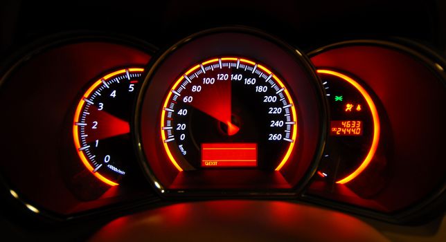 A shot of the car dashboard glowing while stationary