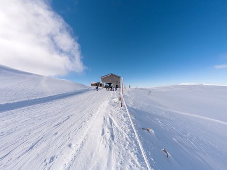 Parnassos mountain with snow and people on the slopes in a sunny day