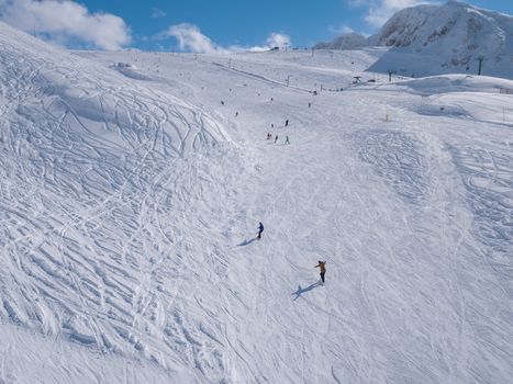 Parnassos mountain with snow and people on the slopes in a sunny day