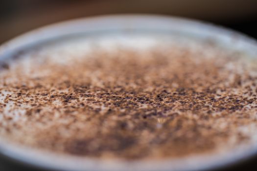 A cup of cappuccino coffee in a cafe setting