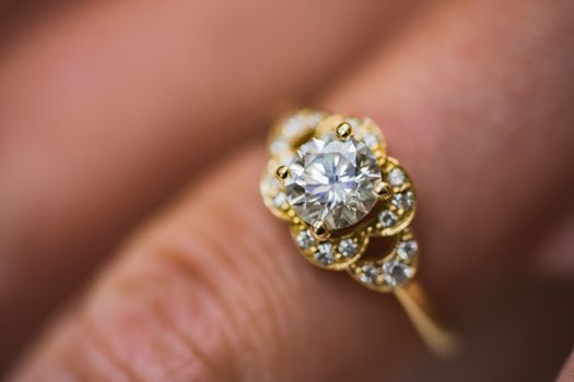 A close up of a beautiful gold diamond engagement ring