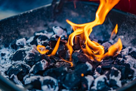 A close up of a fire from a barbecue or fire pit