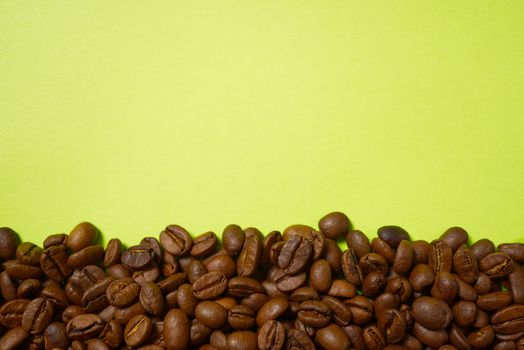 Texture of coffee beans. Roasted coffee beans background. close up Coffee beans with copy space on green background.