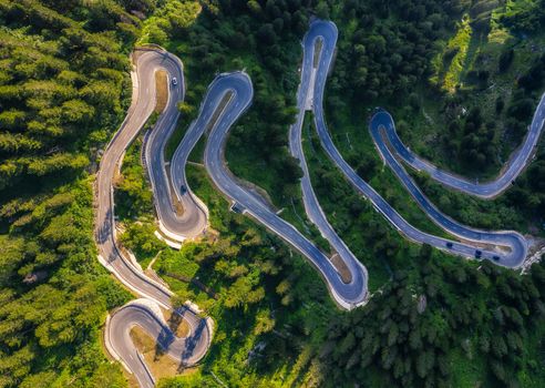 Aerial view of Maloja Pass road in Switzerland. This Swiss Alps mountain road is located in dense forests of the canton Graubunden.
