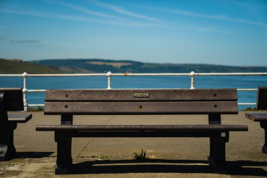 A wooden bench on a seaside pier in the UK